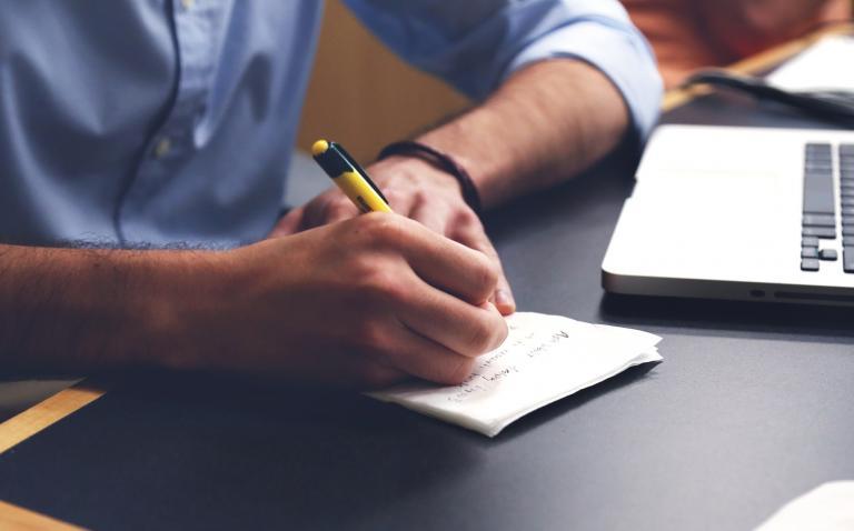 hand with pen and computer