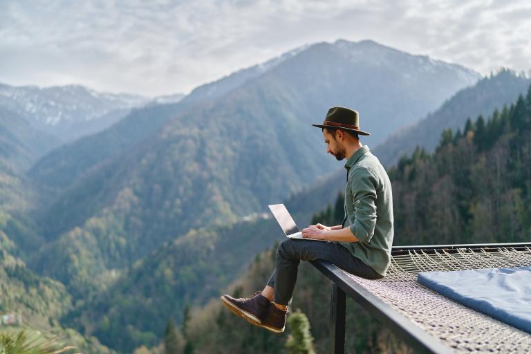 man with mountains in the background