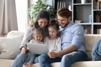 family in front of a laptop